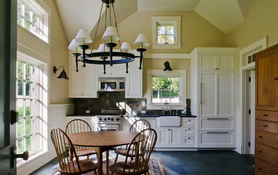Kitchen with classic white cabinets and cathedral ceiling