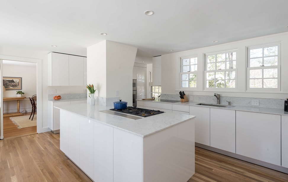 Overall view of full kitchen renovation with white statement island in Chestnut Hill MA
